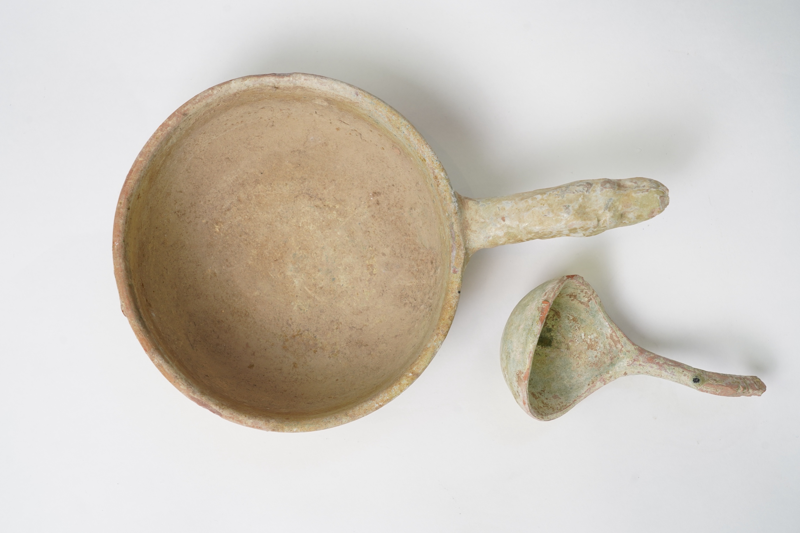 A Chinese earthenware scoop and a similar ladle, Han Dynasty (1st-2nd century A.D.)